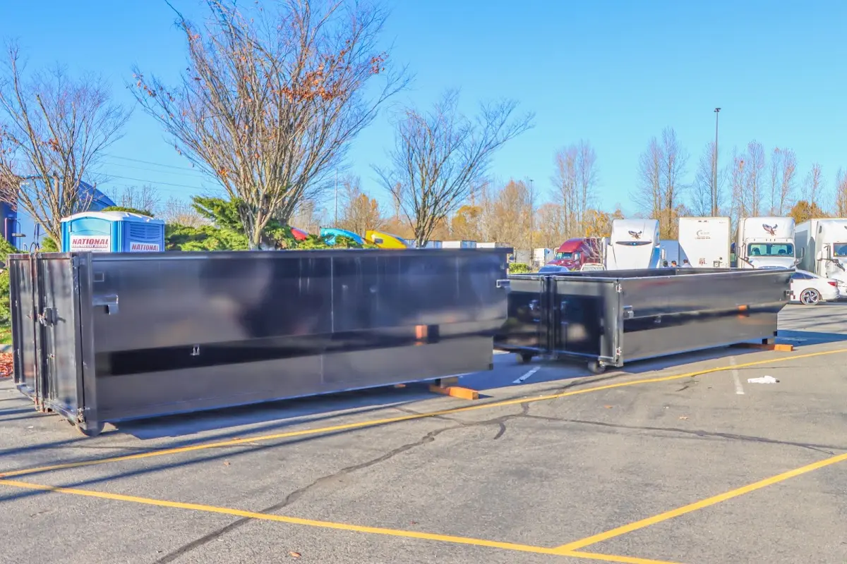 Professional dumpster rental service with roll-off container on residential driveway in Bradenton